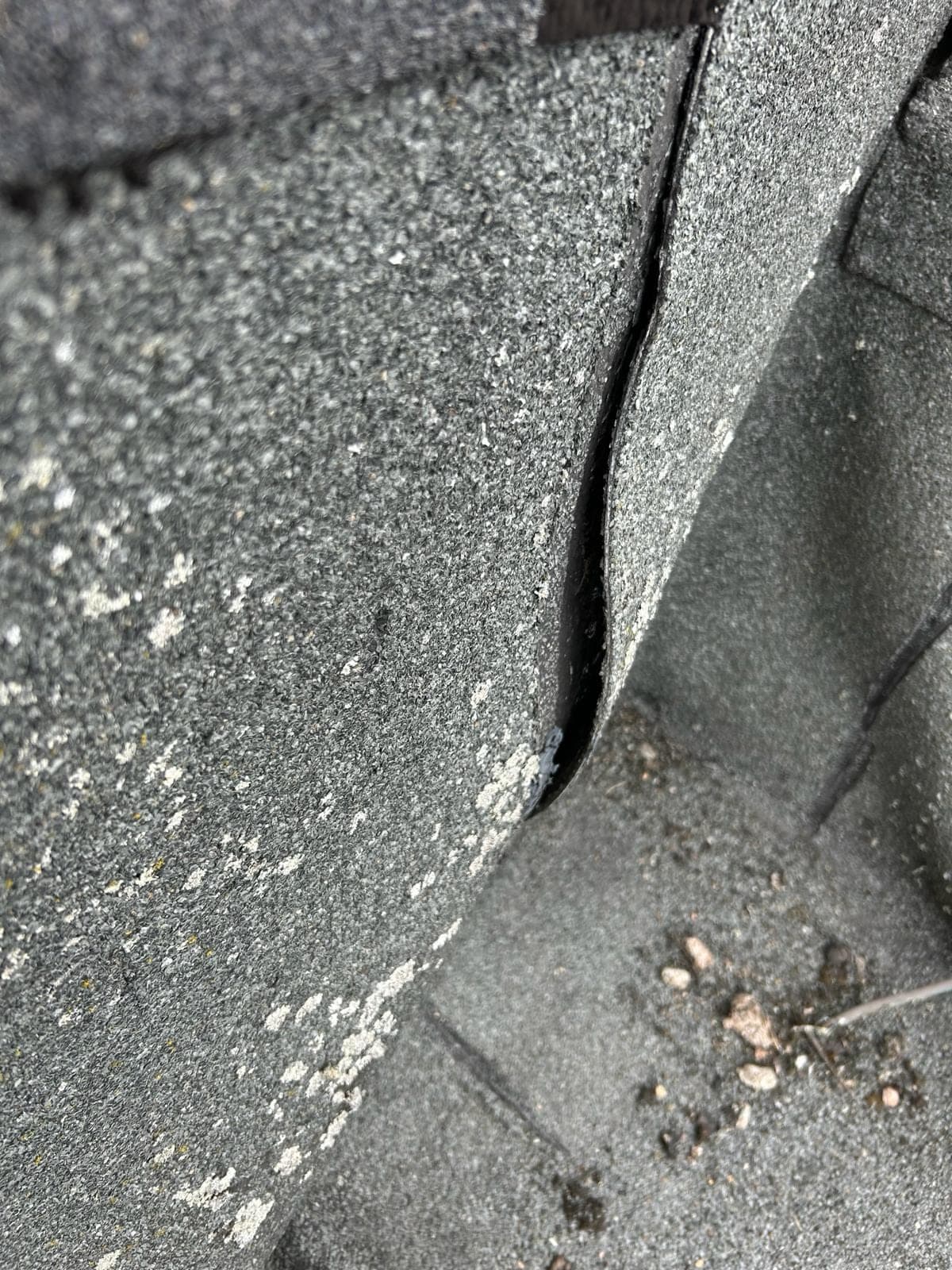 Detail van scheur en losse naad in plat bitumendak, klassiek beeld bij dakreparaties